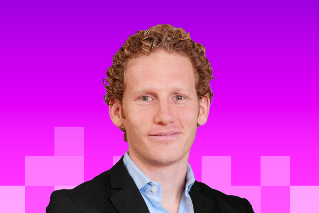 Headshot of Jonah Berger - white man in a suit with curly red hair