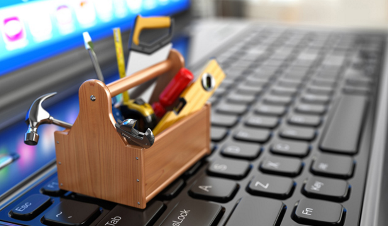 a little toolbox of tools on a laptop keyboard representing accessibility tools