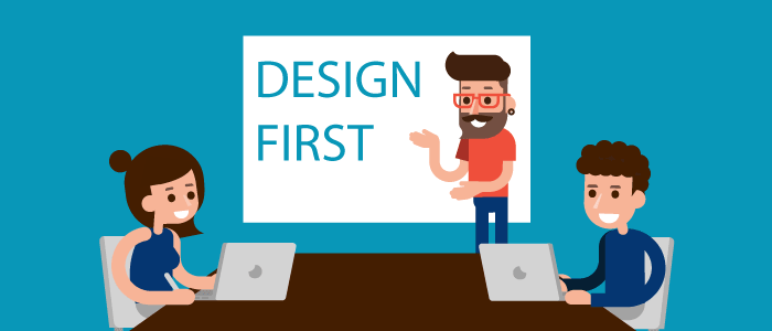Designer at head of conference table presenting design-first concept
